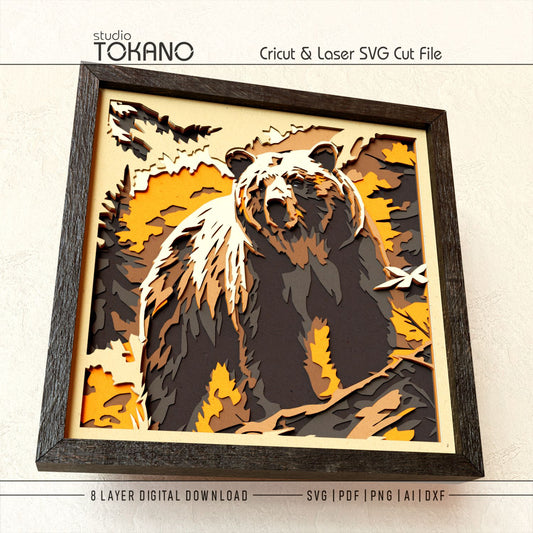 Close-up of the bear shadow box cut file showing clean layered cardstock detail, forest shapes, realistic grizzly features, and crisp papercut lines.