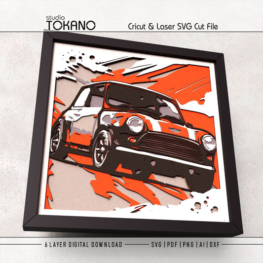 Mini Cooper papercut wall art displayed in a shadow box frame, featuring bold car details and dimensional 3D layered cardstock construction.