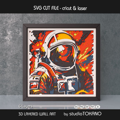 Framed astronaut layered wall art shown as a bold space papercut design with fiery colors and 3D depth.