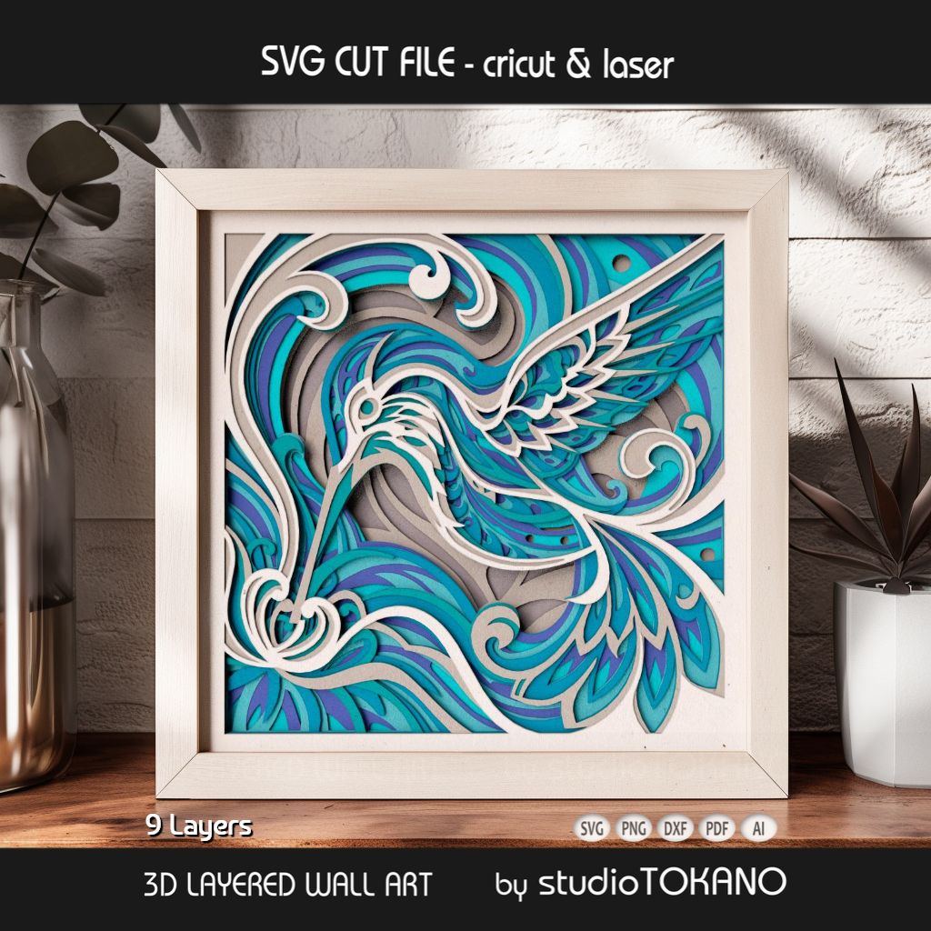 Floral hummingbird papercut wall art displayed in a shadow box frame as elegant nature-inspired handmade decor.