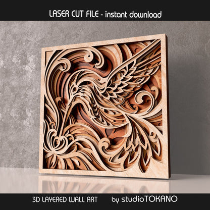 Hummingbird layered laser cut design displayed in wood tones, showing the elegant bird shape, floral details, and dimensional laser-cut layers.