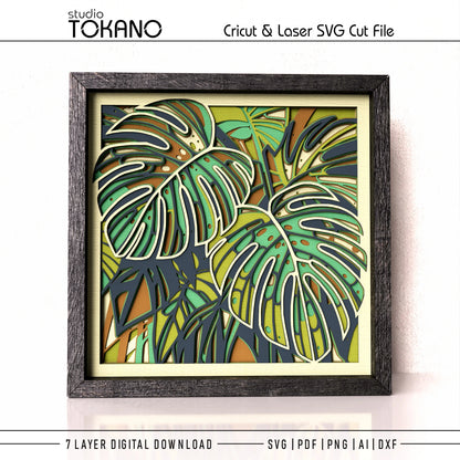A framed tropicalmonstera  leaf cut file design featuring layered monstera leaves in green, yellow, and dark navy tones, presented as a digital SVG cut file product with text overlays.