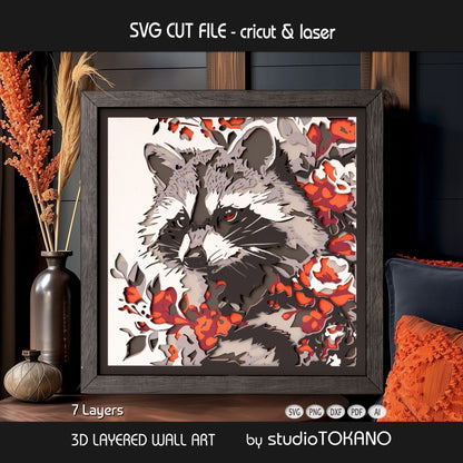 Framed raccoon layered wall art shown in a warm interior setting, highlighting the 3D depth and stacked cardstock layers.