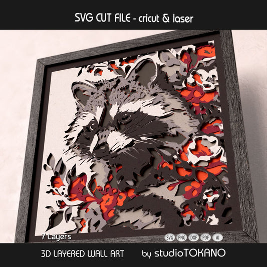 Woodland raccoon papercut wall art displayed in a shadow box frame with strong dimensional cardstock depth.